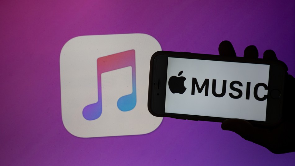 The logo of the music streaming app Apple Music is seen on a mobile screen and a laptop screen. The numbers of people using music streaming apps grow. The biggest one is the Swedish Spotify with 83 million paying users and about 100 others, that use the free version. (Photo by Alexander Pohl/NurPhoto via Getty Images)