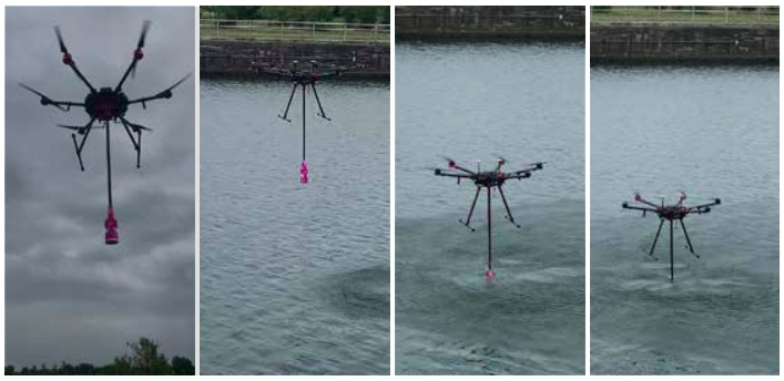 A drone dips a sample container in a river.